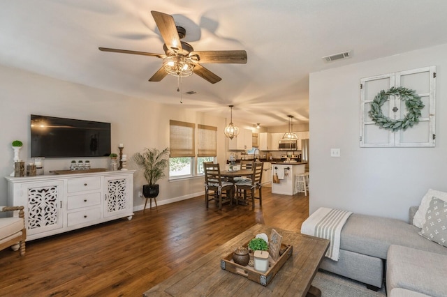 living room featuring ceiling fan and dark hardwood / wood-style flooring