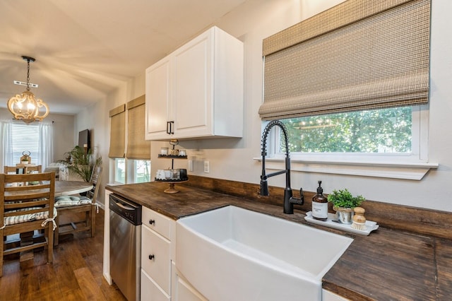 kitchen featuring stainless steel dishwasher, white cabinetry, sink, and a healthy amount of sunlight