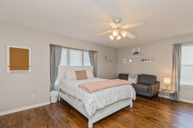 bedroom with dark hardwood / wood-style floors and ceiling fan