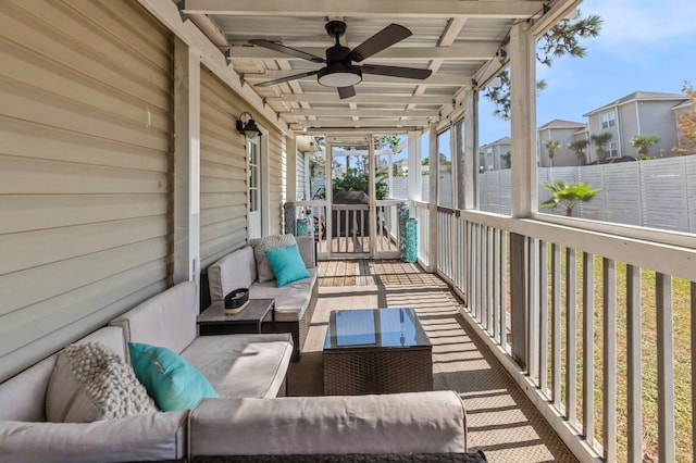 wooden deck with an outdoor living space and ceiling fan