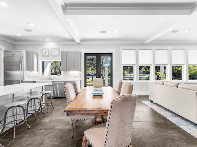 968 Don Bishop Rd, Santa Rosa Beach, FL 32459 - dining area with beamed ceiling, stone tile floors, ornamental molding, recessed lighting, and baseboards