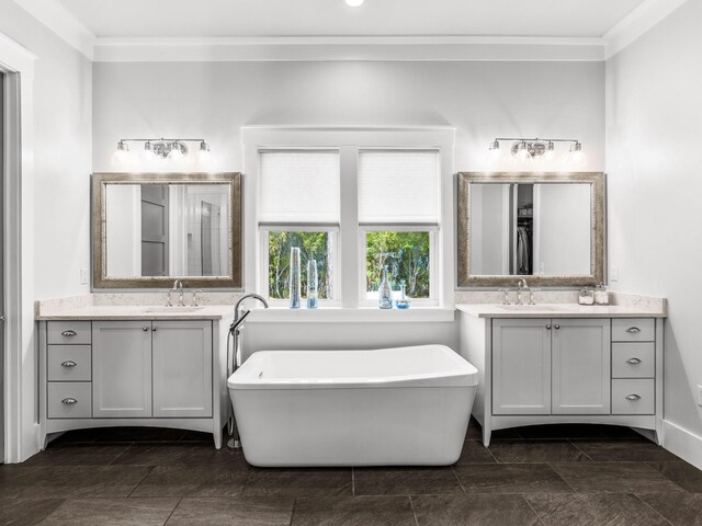 bathroom featuring vanity, a tub to relax in, and crown molding