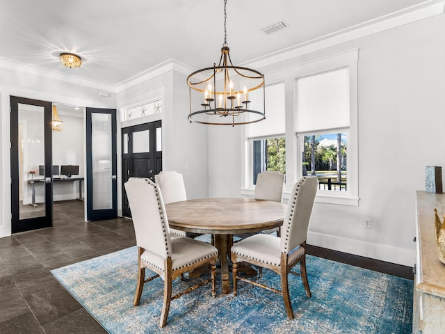 dining space featuring french doors, a chandelier, and crown molding