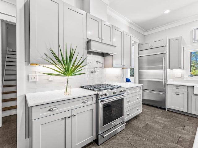 968 Don Bishop Rd, Santa Rosa Beach, FL 32459 - kitchen with appliances with stainless steel finishes, custom exhaust hood, crown molding, tasteful backsplash, and recessed lighting