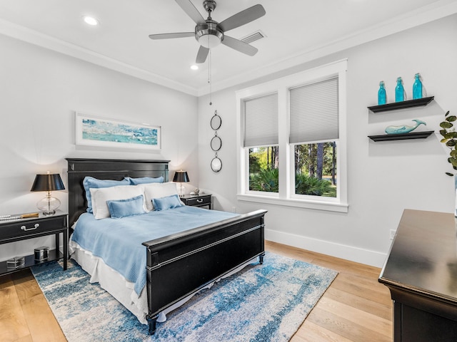 bedroom featuring crown molding, ceiling fan, and light hardwood / wood-style flooring