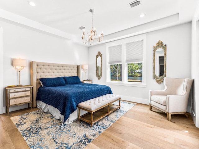 968 Don Bishop Rd, Santa Rosa Beach, FL 32459 - bedroom with a chandelier, recessed lighting, wood finished floors, a tray ceiling, and baseboards