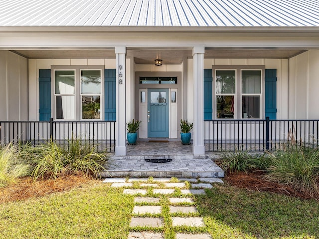 968 Don Bishop Rd, Santa Rosa Beach, FL 32459 - view of exterior entry featuring a porch, board and batten siding, and metal roof