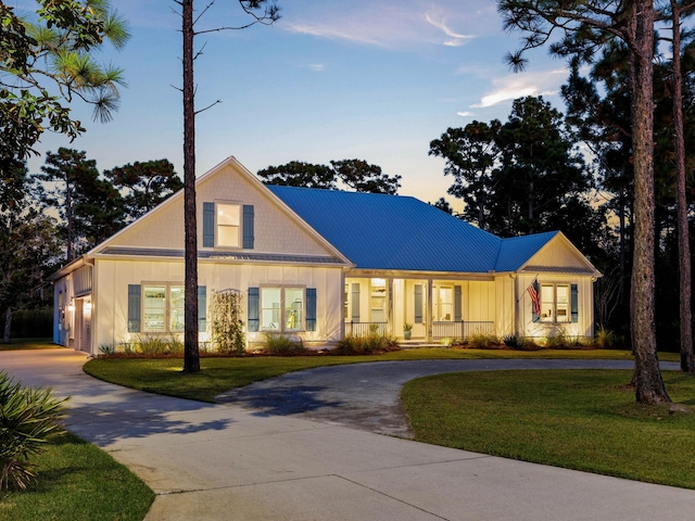 968 Don Bishop Rd, Santa Rosa Beach, FL 32459 - modern farmhouse with curved driveway, covered porch, a yard, and metal roof