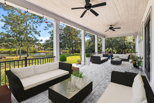 view of patio / terrace featuring a water view and an outdoor living space