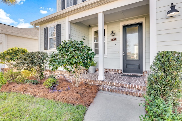 entrance to property featuring covered porch