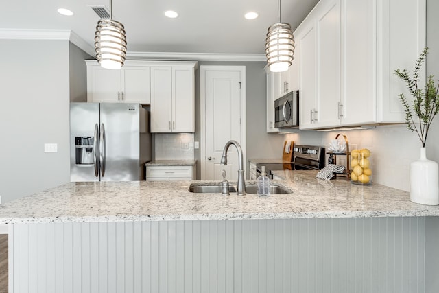 kitchen featuring decorative light fixtures, white cabinetry, sink, and appliances with stainless steel finishes