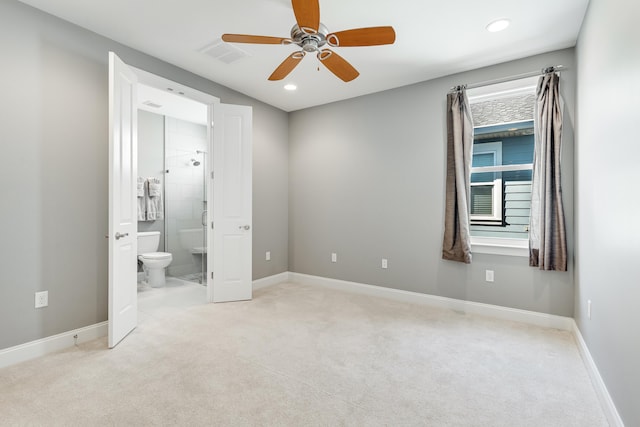 unfurnished bedroom featuring light carpet, ensuite bath, and ceiling fan