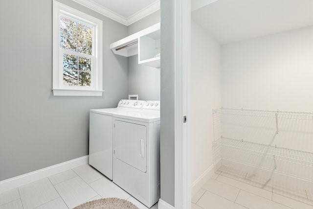 laundry area featuring light tile patterned floors, washer and dryer, and ornamental molding