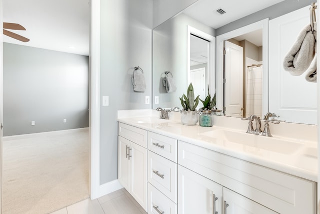 bathroom with tile patterned floors, vanity, and ceiling fan