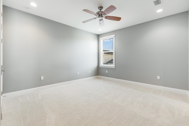 unfurnished room with ceiling fan and light carpet