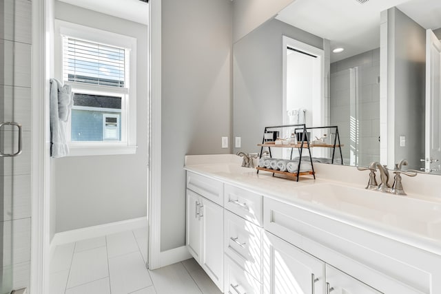 bathroom with tile patterned flooring, vanity, and a shower with shower door