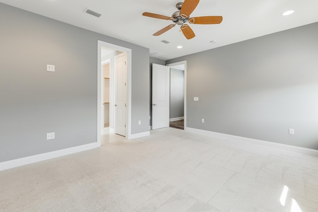 unfurnished bedroom featuring ceiling fan and light carpet