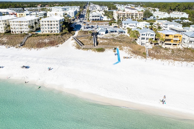 aerial view with a water view and a beach view