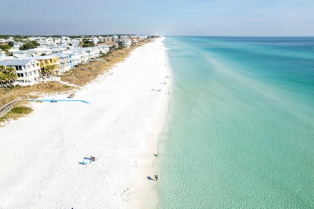 drone / aerial view with a beach view and a water view