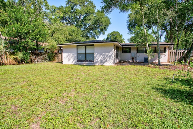 rear view of house featuring a lawn