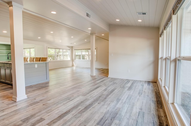 unfurnished living room with sink, wooden ceiling, lofted ceiling, and light wood-type flooring