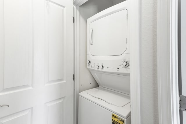 washroom featuring laundry area and stacked washer / drying machine