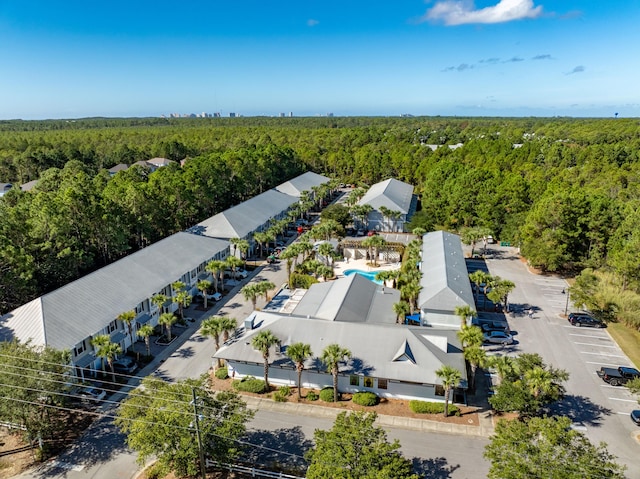 birds eye view of property featuring a view of trees