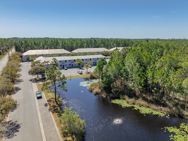 bird's eye view with a forest view and a water view