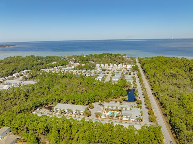 aerial view with a forest view and a water view