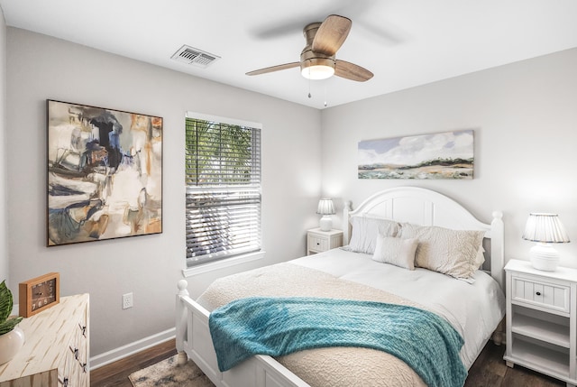 bedroom with visible vents, ceiling fan, baseboards, and dark wood-style flooring