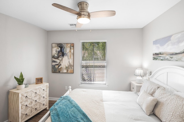 bedroom with baseboards, wood finished floors, and a ceiling fan