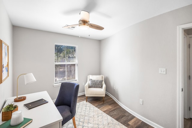 home office with a ceiling fan, visible vents, wood finished floors, and baseboards