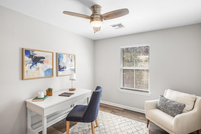 office featuring baseboards, wood finished floors, visible vents, and ceiling fan