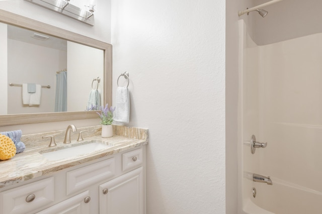 bathroom with visible vents, shower / tub combo with curtain, and vanity