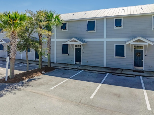 multi unit property with metal roof and uncovered parking