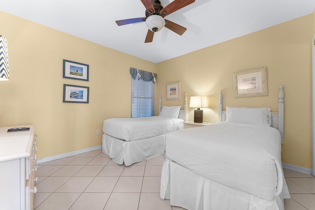 tiled bedroom featuring ceiling fan