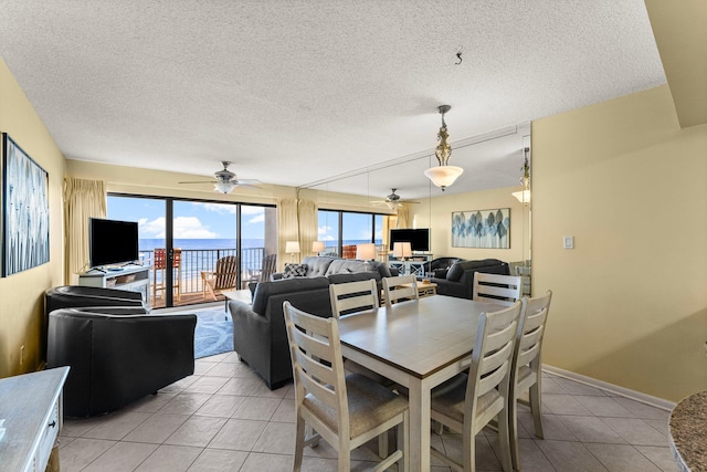 dining space with light tile patterned floors, a textured ceiling, and ceiling fan