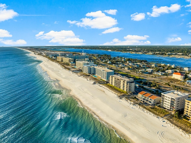 bird's eye view with a water view and a beach view