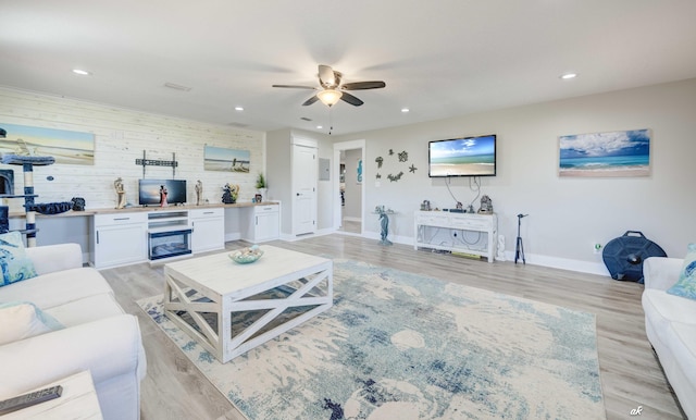 248 Sukoshi Dr, Panama City, FL 32404 - living area featuring a ceiling fan, recessed lighting, light wood finished floors, baseboards, and wood walls