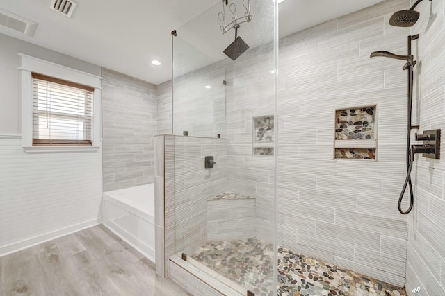 248 Sukoshi Dr, Panama City, FL 32404 - bathroom featuring tiled shower, wood finished floors, and a garden tub