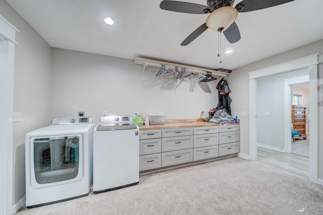 laundry room with cabinets, light colored carpet, washing machine and dryer, and ceiling fan