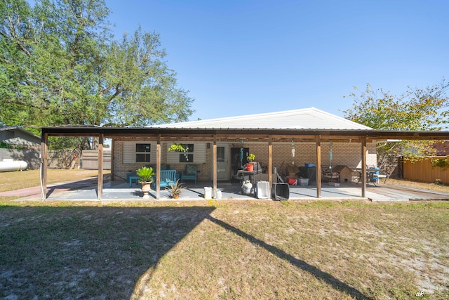 back of property featuring a yard and a patio area