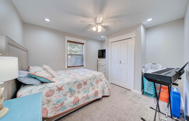 carpeted bedroom featuring ceiling fan and a closet