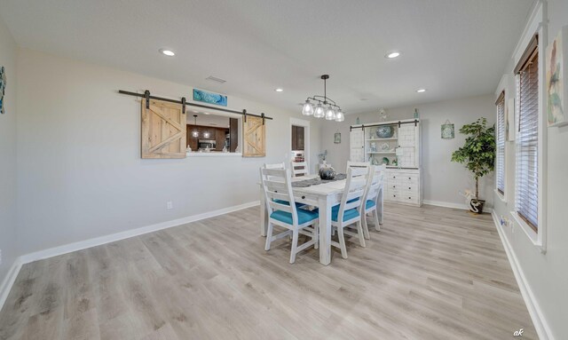 248 Sukoshi Dr, Panama City, FL 32404 - dining space featuring a barn door, light wood-style floors, recessed lighting, and baseboards