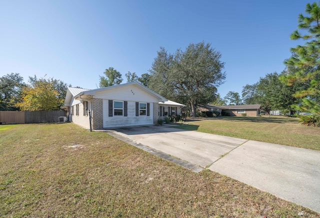 view of front of house with a front lawn and cooling unit