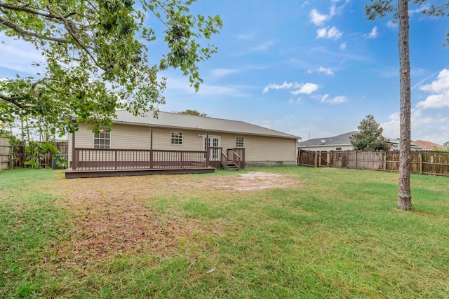 back of house featuring a yard and a deck