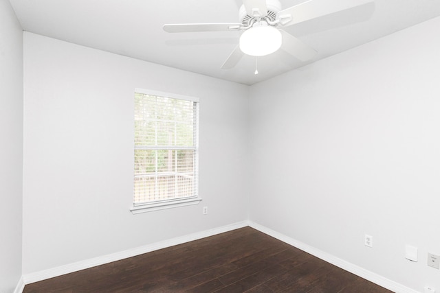 empty room with dark hardwood / wood-style flooring and ceiling fan