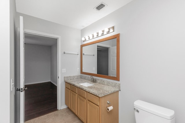 bathroom featuring hardwood / wood-style floors, vanity, and toilet