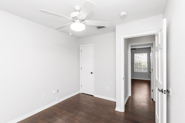 unfurnished room featuring ceiling fan and dark hardwood / wood-style floors