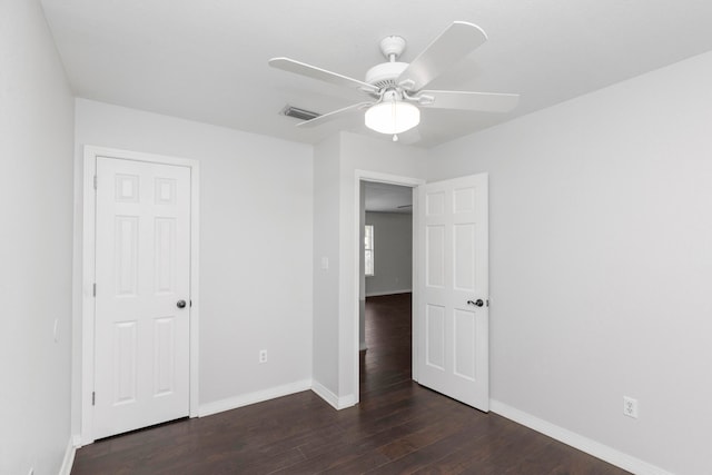 unfurnished bedroom with ceiling fan and dark hardwood / wood-style floors